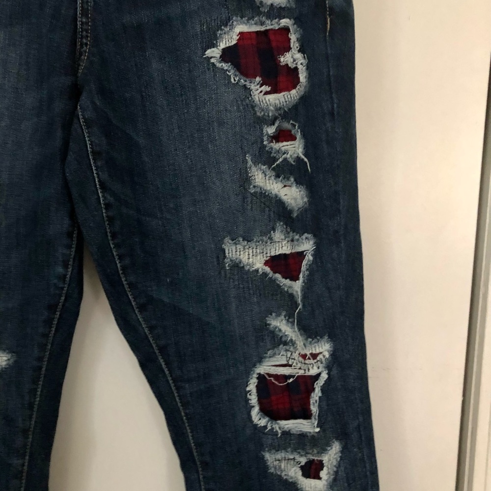 Torrid premium boyfriend jeans with navy blue/red plaid fabric under the rips